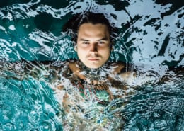 tattooed man in the pool in the rain close-up portrait outdoors | Fiesta Pools and Spas What to Expect Your First Week of Cold Plunging